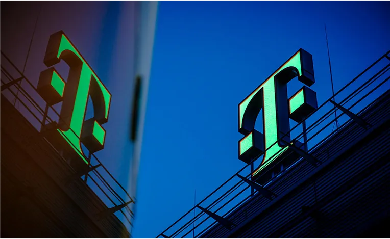 Green Telekom logo is mirrored in a building next to it (Photo)