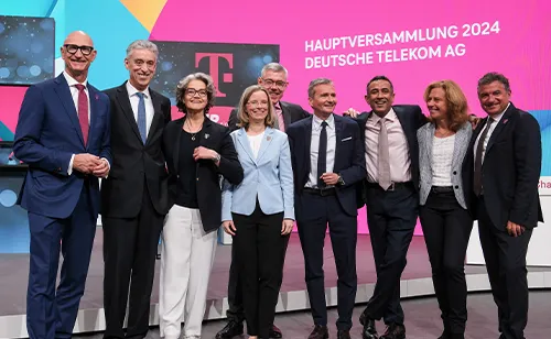 Board of Management of Deutsche Telekom standing and smiling