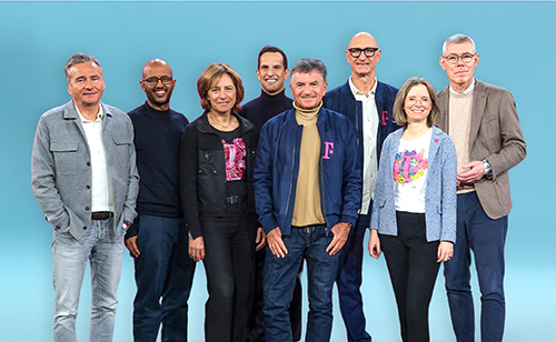 Board of Management of Deutsche Telekom standing and smiling
